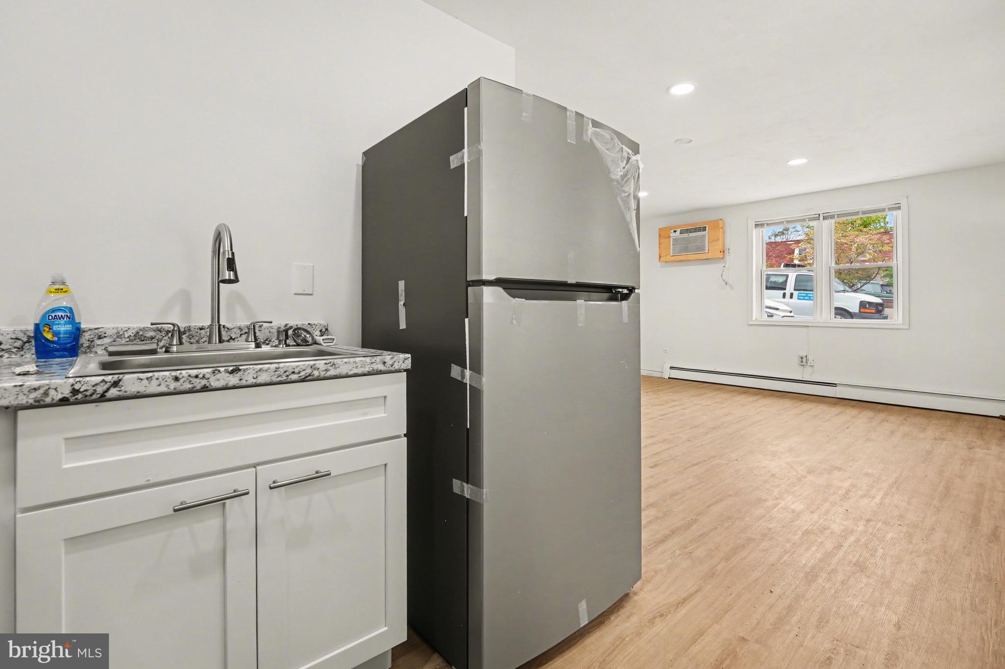 107 Allison Road Oreland, PA 19075 - Photo 9 of 54 a kitchen with a refrigerator and a stove top oven