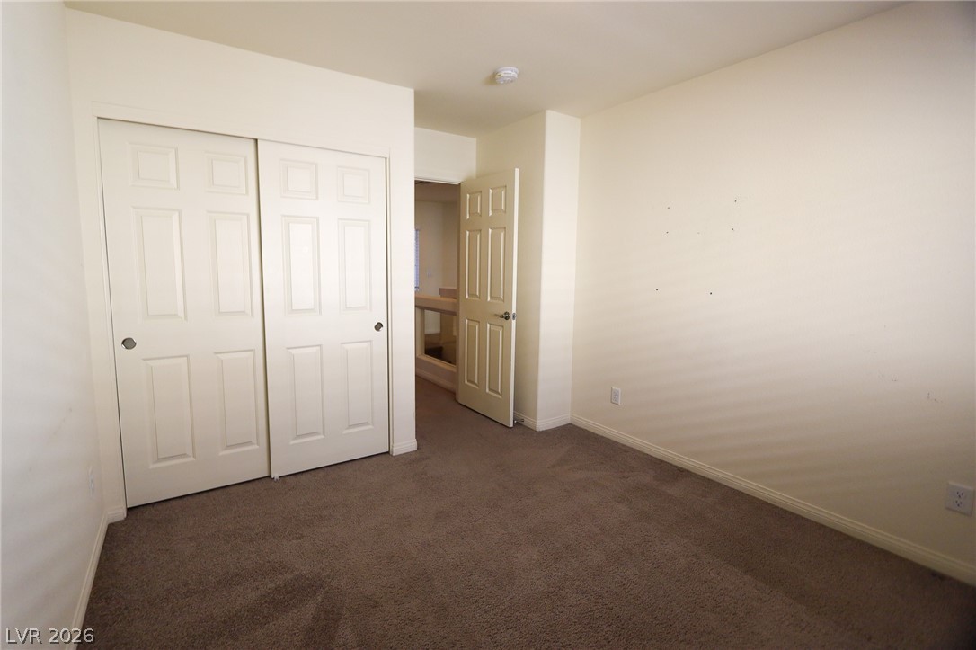 6418 Jackson Spring Road Las Vegas, NV 89118 - Photo 15 of 20 A well-proportioned bedroom features soft carpeting and ample closet space with classic paneled doors.