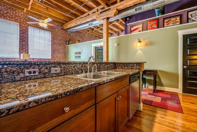 a kitchen with granite countertop stainless steel appliances and wooden cabinets