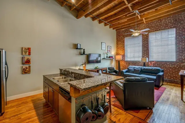a living room with furniture and a flat screen tv