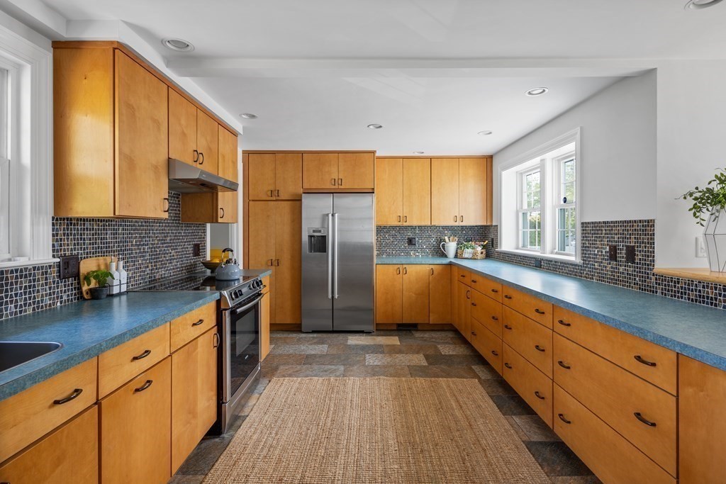 67 Randlett Park Newton, MA 02465 - Photo 11 of 41 a kitchen with stainless steel appliances a refrigerator sink and wooden cabinets