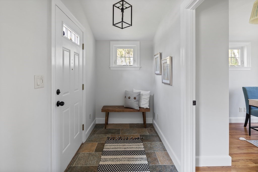 67 Randlett Park Newton, MA 02465 - Photo 19 of 41 a hallway with painting on the wall and a window