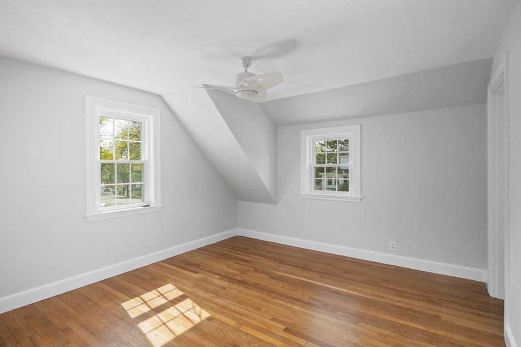 67 Randlett Park Newton, MA 02465 - Photo 25 of 41 a view of an empty room with wooden floor and a window