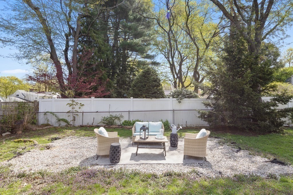 67 Randlett Park Newton, MA 02465 - Photo 39 of 41 a view of a backyard with table and chairs potted plants and large tree