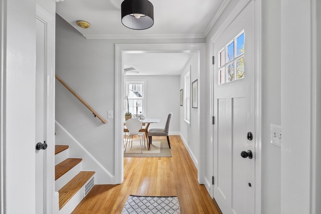 67 Randlett Park Newton, MA 02465 - Photo 7 of 41 a view of a hallway to a livingroom with furniture and staircase