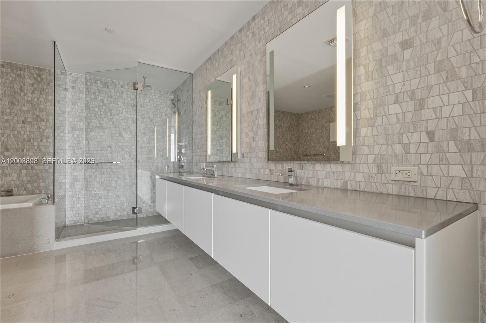 88 Southwest 7th Street, Unit 3710 Miami, FL 33130 - Photo 14 of 21 a bathroom with a double vanity sink and mirror with bathtub