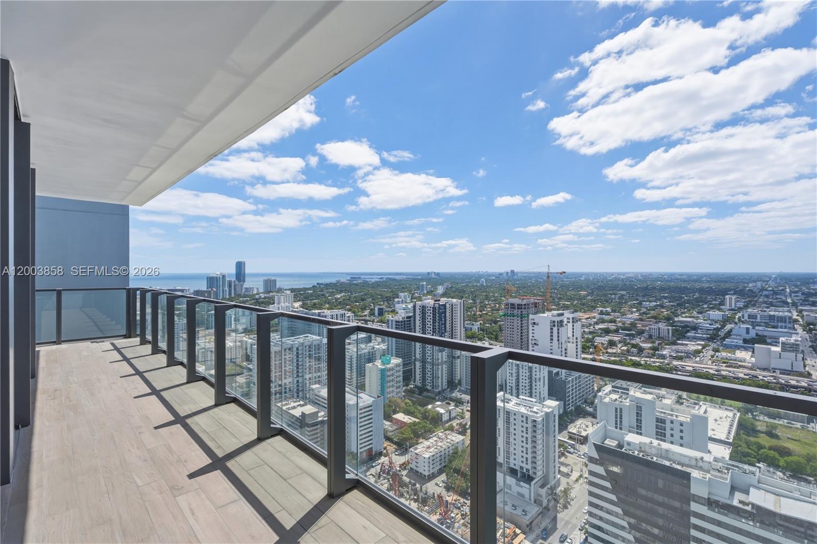 88 Southwest 7th Street, Unit 3710 Miami, FL 33130 - Photo 16 of 21 a view of a balcony with wooden floor & fence