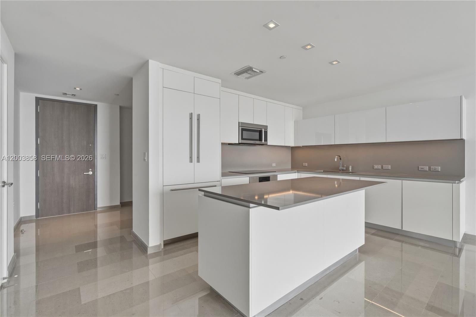 88 Southwest 7th Street, Unit 3710 Miami, FL 33130 - Photo 3 of 21 a kitchen with stainless steel appliances granite countertop a sink stove and refrigerator