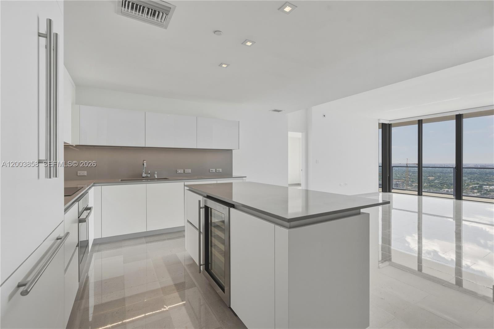 88 Southwest 7th Street, Unit 3710 Miami, FL 33130 - Photo 4 of 21 a kitchen with stainless steel appliances granite countertop a sink and a refrigerator