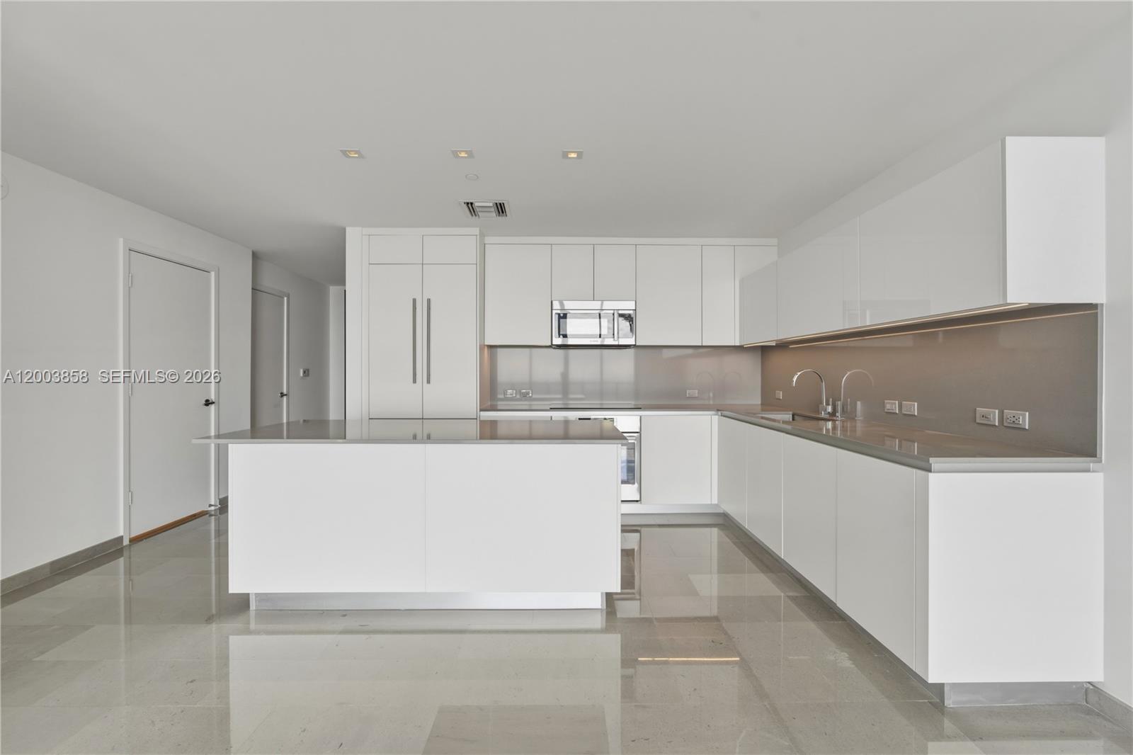 88 Southwest 7th Street, Unit 3710 Miami, FL 33130 - Photo 5 of 21 a view of kitchen with refrigerator sink and cabinets