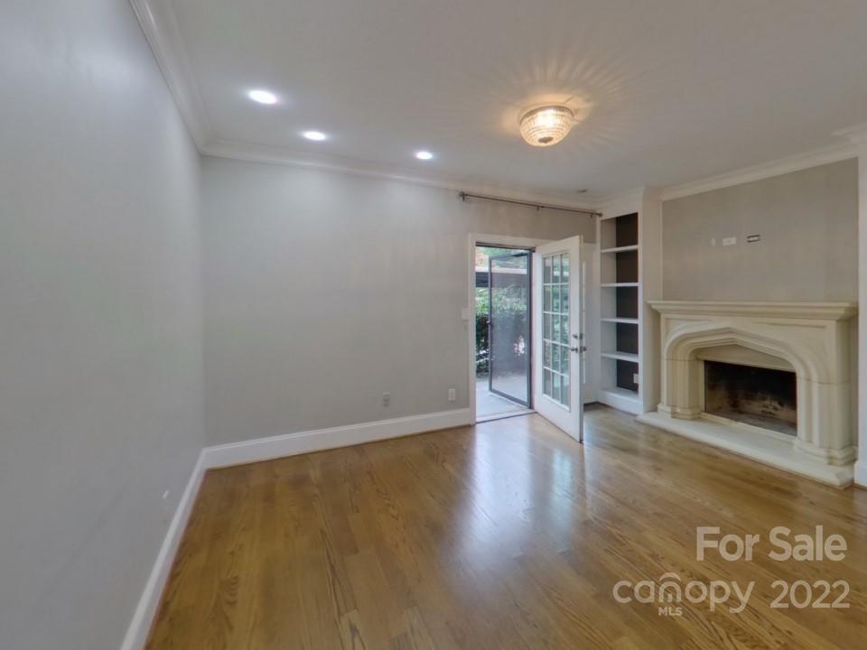 1012 Queens Road Charlotte, NC 28207 - Photo 2 of 13 a view of empty room with wooden floor and fireplace