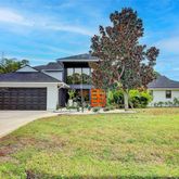 a front view of a house with a yard and garage