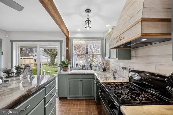 a kitchen with a sink stove and cabinets
