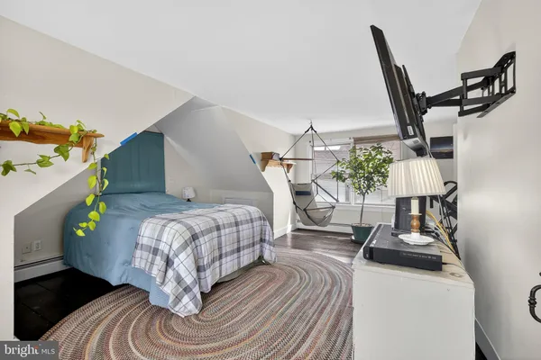 a bedroom with furniture and a wooden floor