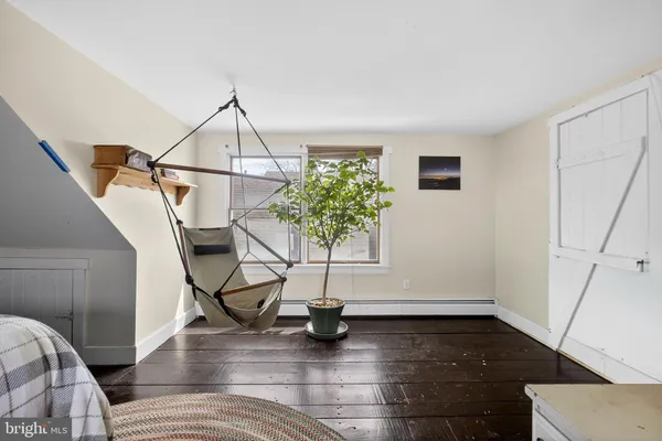 a view of entryway and hall with wooden floor