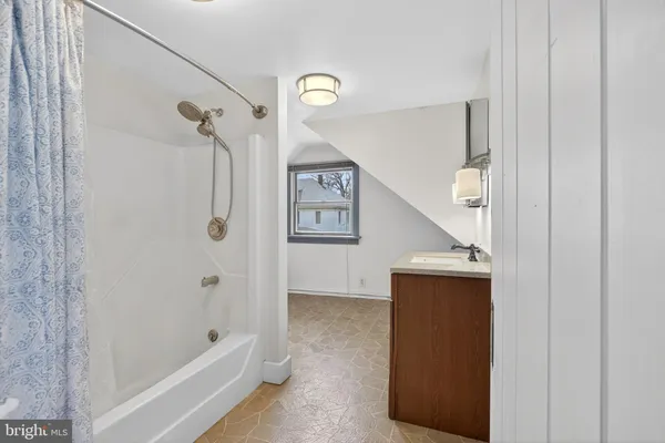 a bathroom with a bathtub and shower
