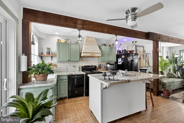 a kitchen with a sink a stove and cabinets