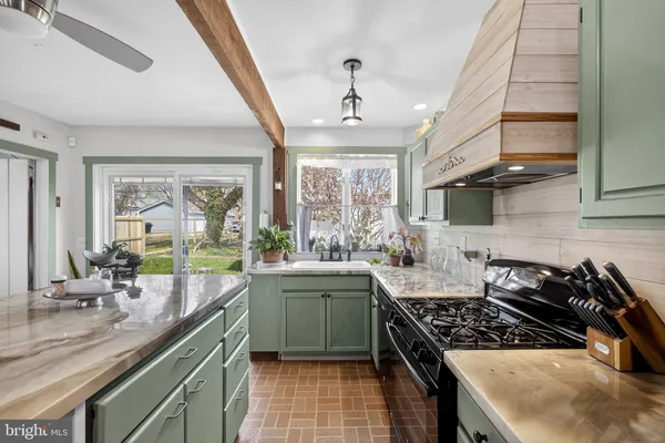 a kitchen with stainless steel appliances granite countertop a sink stove and cabinets