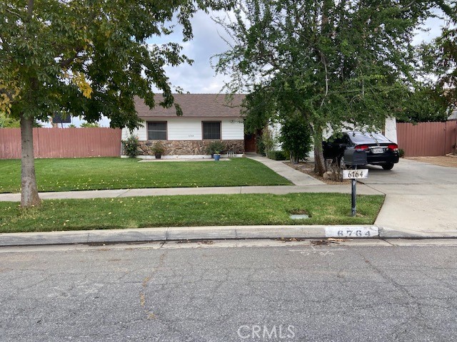 6764 Farrier Avenue Riverside, CA 92503 - Photo 1 of 1 a front view of a house with a yard and garage