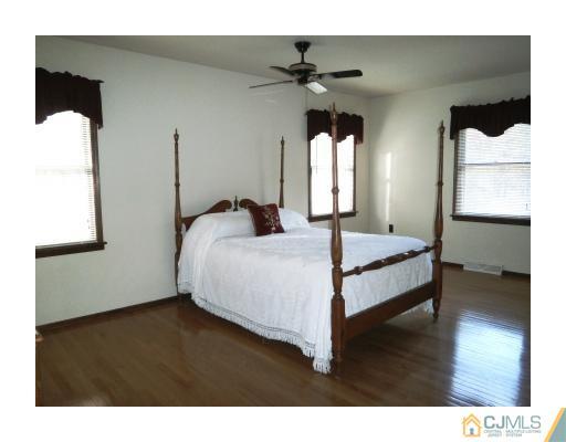 200 Old Forge Road Monroe Township, NJ 08831 - Photo 16 of 25 a bedroom with a bed and a chandelier