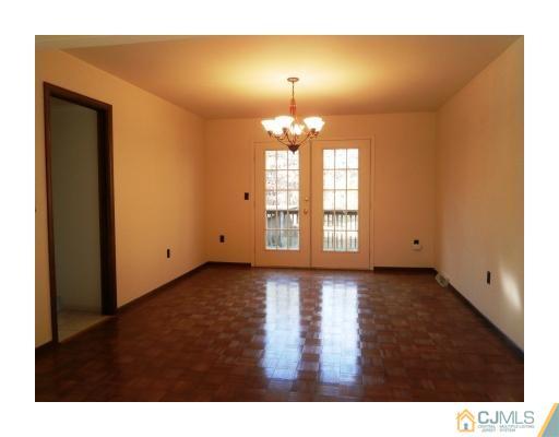 200 Old Forge Road Monroe Township, NJ 08831 - Photo 9 of 25 a view of an empty room with window and wooden floor
