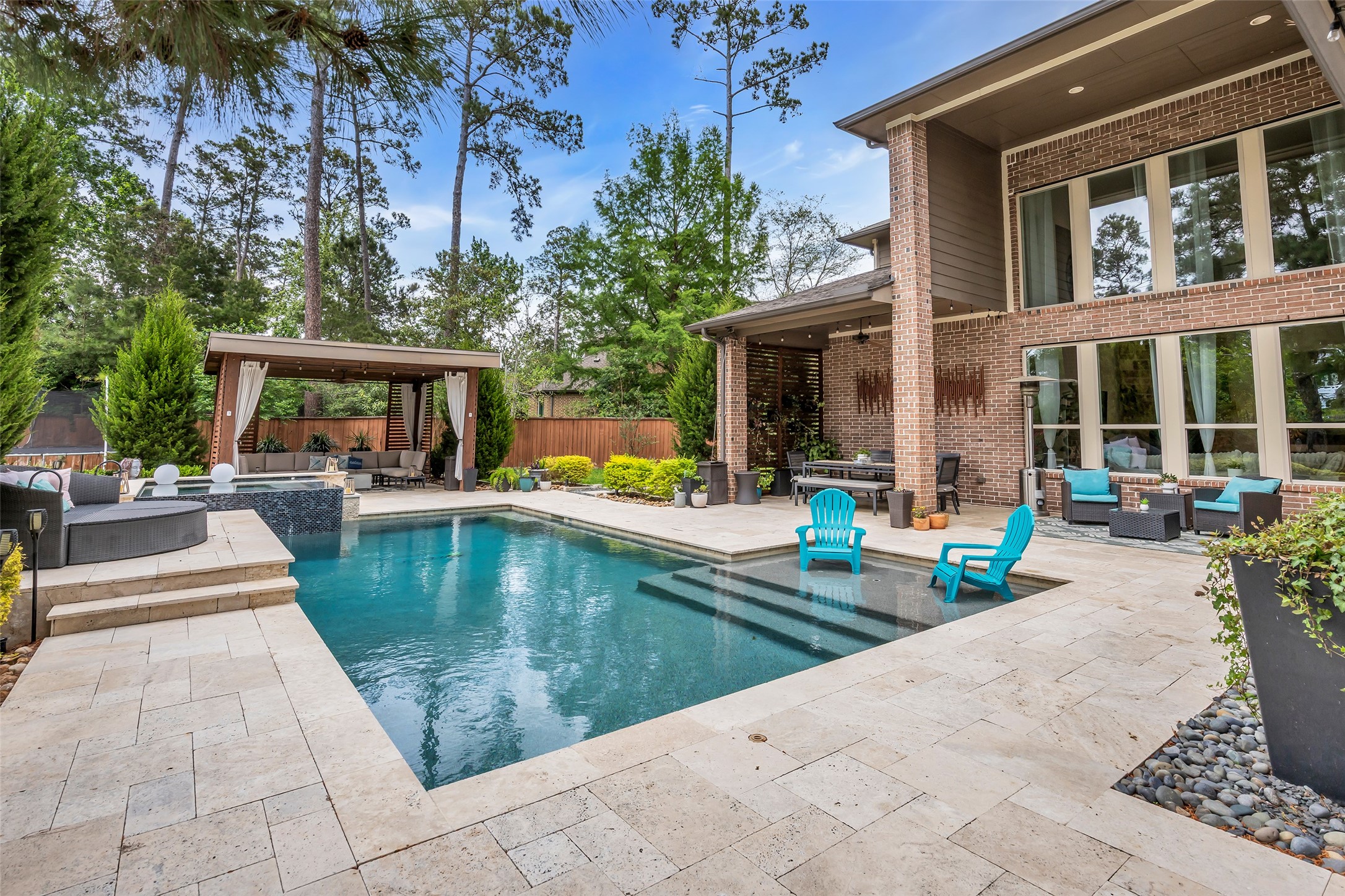143 West Valera Ridge Place Spring, TX 77389 - Photo 1 of 50 swimming pool view with a seating space and a garden view