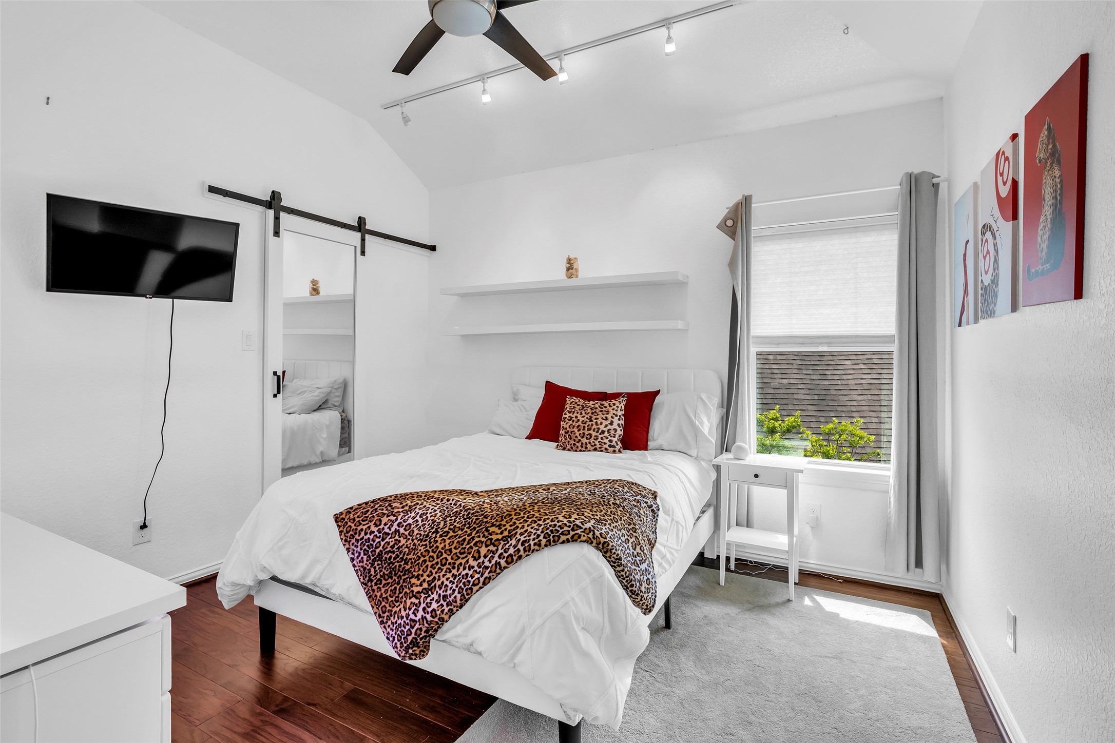 143 West Valera Ridge Place Spring, TX 77389 - Photo 26 of 50 a bedroom with a bed a flat screen tv and a window