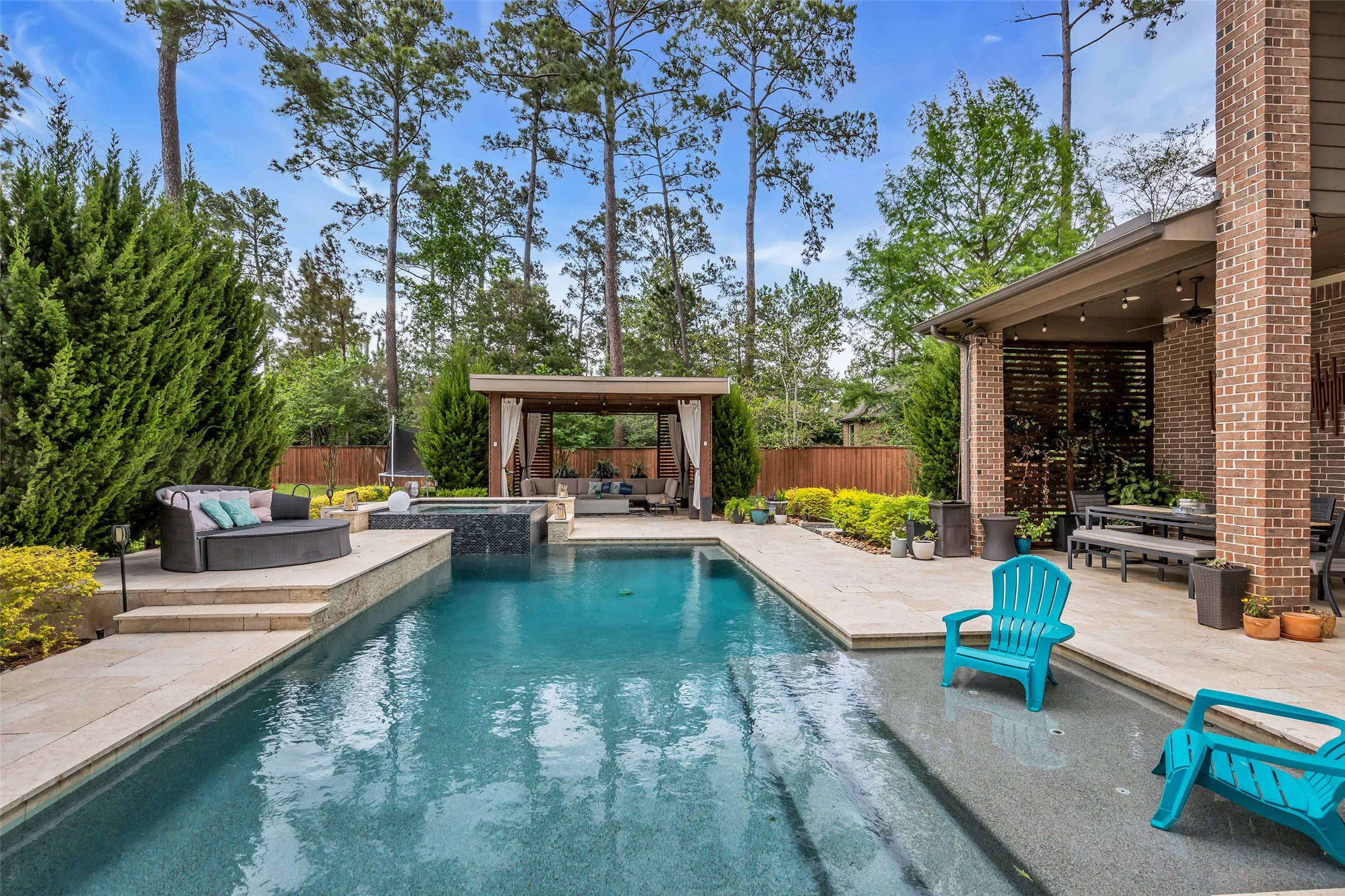 143 West Valera Ridge Place Spring, TX 77389 - Photo 38 of 50 swimming pool with outdoor seating and trees in the background