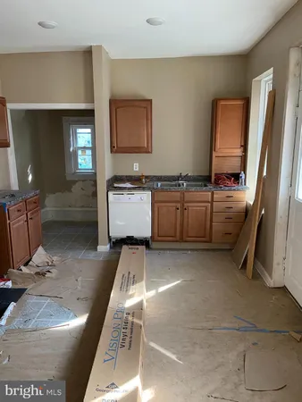 a kitchen with stainless steel appliances granite countertop a sink and a stove