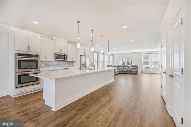 a view of kitchen with sink microwave and stove