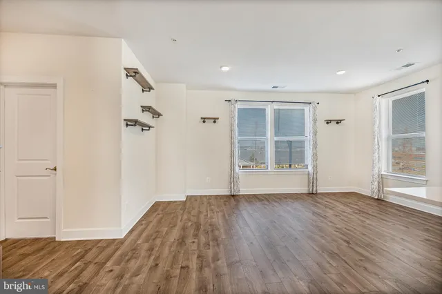 a view of kitchen with wooden floor and electronic appliances