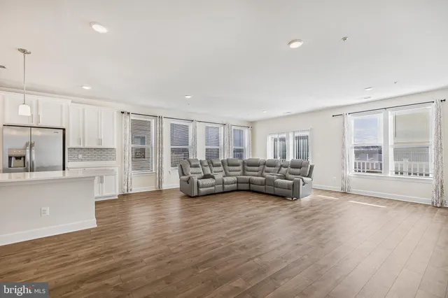 a view of kitchen and hall with wooden floor