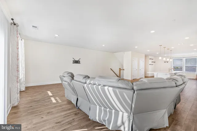 a dining room with furniture and wooden floor