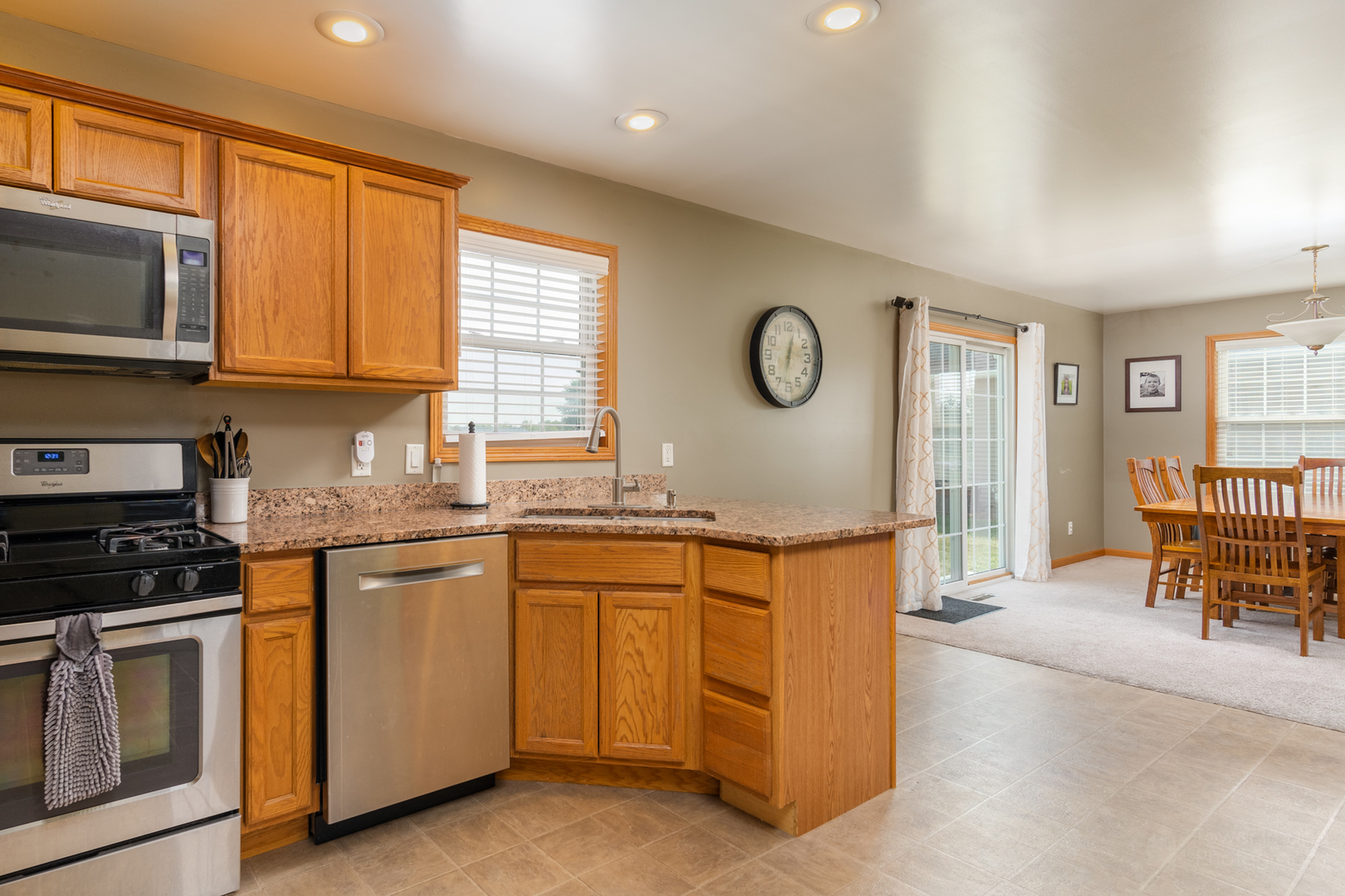 3421 Marquette Road Peru, IL 61354 - Photo 19 of 41 a kitchen with granite countertop a stove top oven sink and cabinets