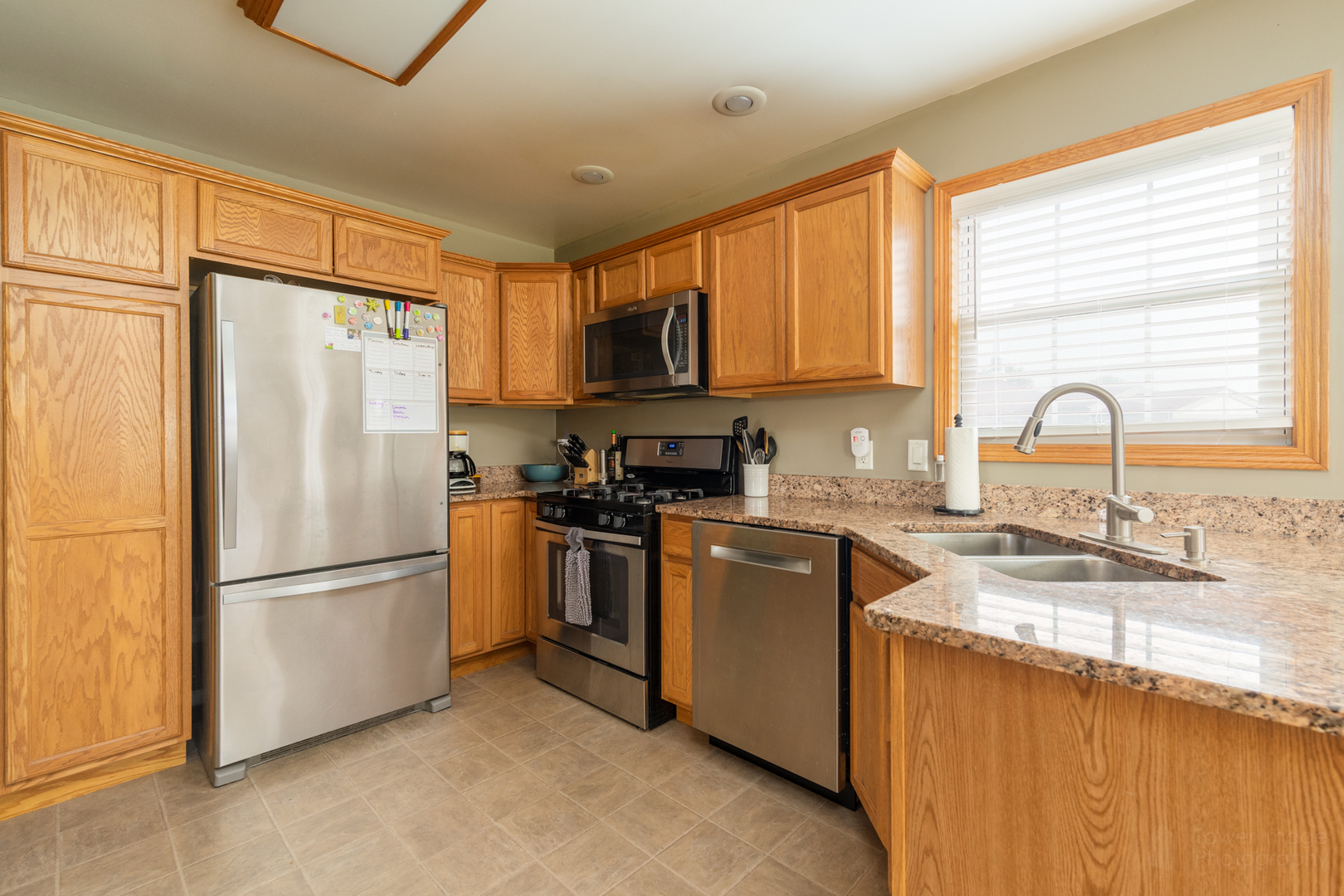 3421 Marquette Road Peru, IL 61354 - Photo 20 of 41 a kitchen with granite countertop a refrigerator stove top oven and sink