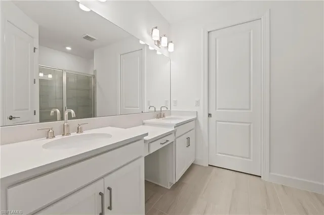 a bathroom with a double vanity sink and a mirror