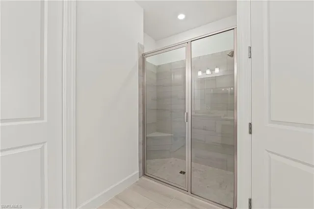 a bathroom with a glass shower door