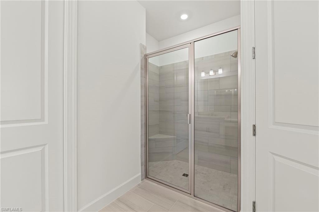 15517 Vittorio Street Naples, FL 34114 - Photo 13 of 35 Bathroom featuring a shower stall, baseboards, and recessed lighting
