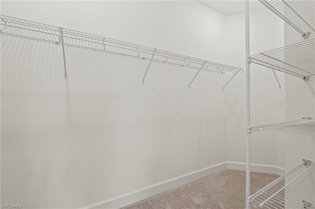 15517 Vittorio Street Naples, FL 34114 - Photo 14 of 35 Spacious closet featuring carpet floors