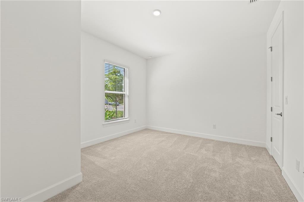 15517 Vittorio Street Naples, FL 34114 - Photo 15 of 35 Spare room featuring light carpet and baseboards