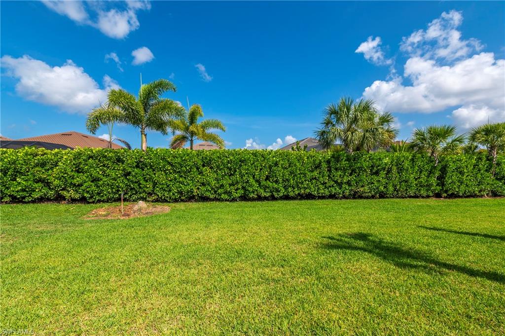 15517 Vittorio Street Naples, FL 34114 - Photo 23 of 35 View of green lawn
