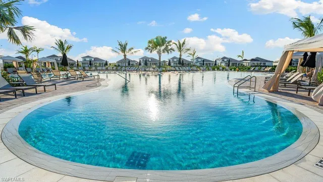 a swimming pool with outdoor seating and lake view