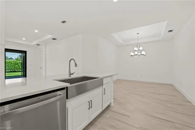 a kitchen with a sink cabinets and window