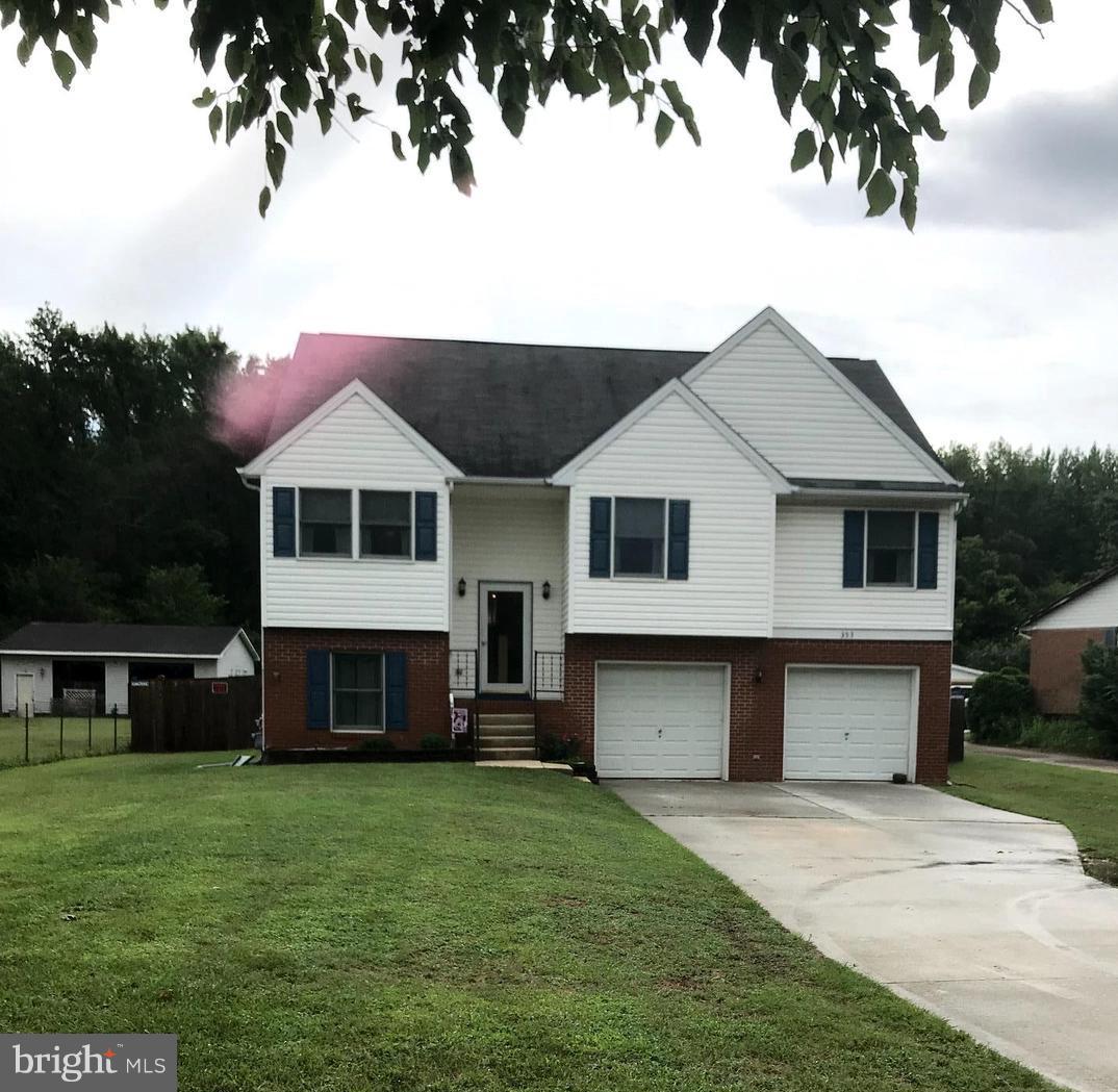 353 Back River Neck Road Baltimore, MD 21221 - Photo 2 of 23 a front view of a house with a garden and yard