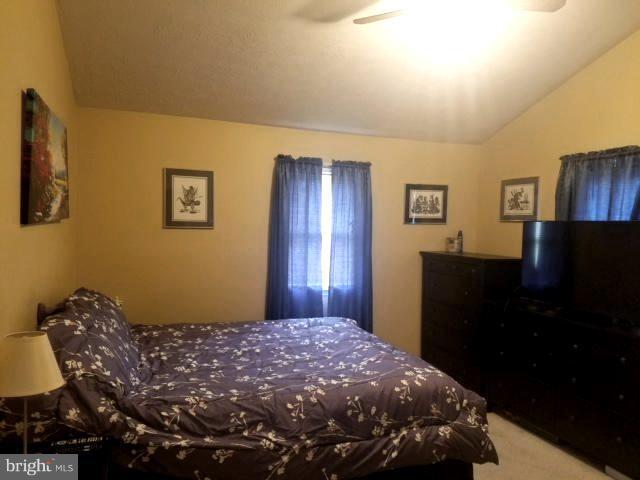 353 Back River Neck Road Baltimore, MD 21221 - Photo 12 of 23 a bedroom with a bed and wooden floor