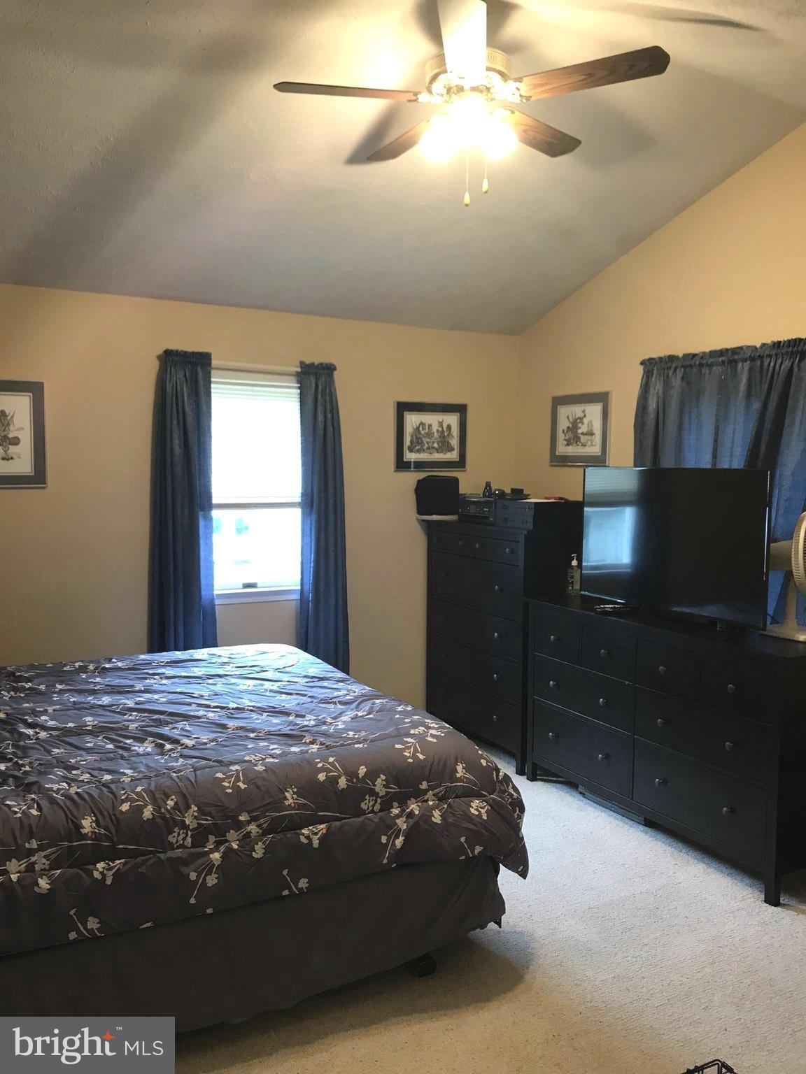 353 Back River Neck Road Baltimore, MD 21221 - Photo 13 of 23 a bedroom with a bed and a dresser