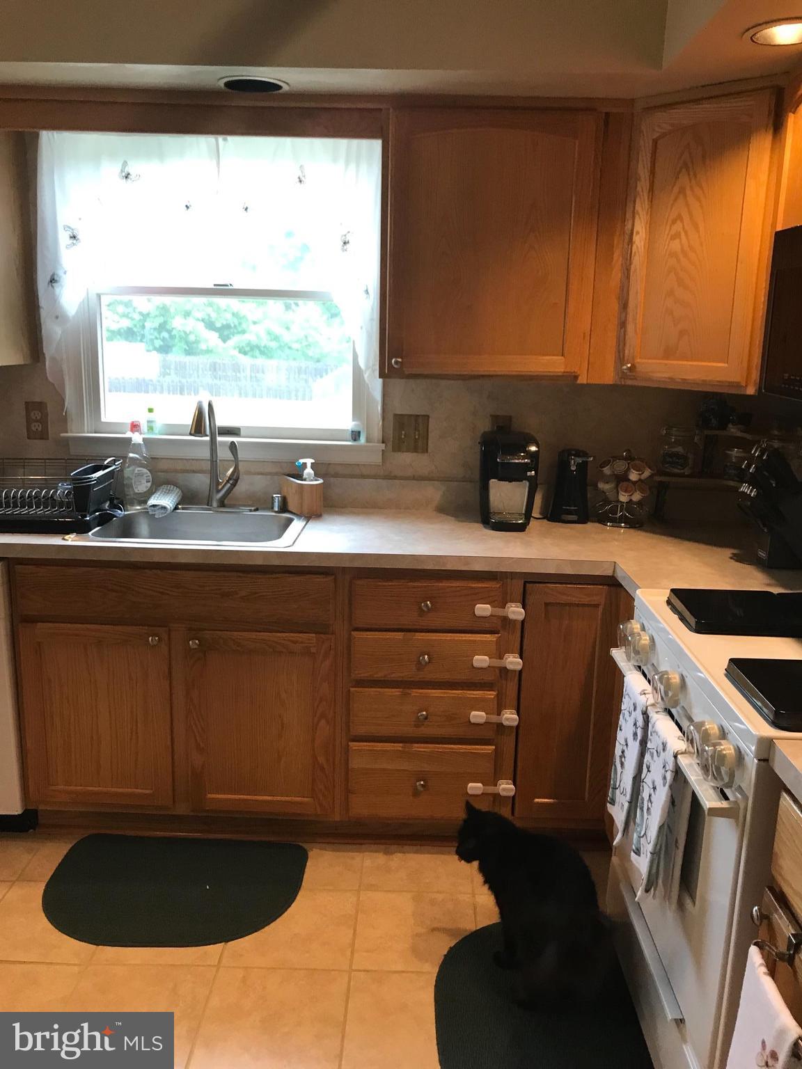 353 Back River Neck Road Baltimore, MD 21221 - Photo 8 of 23 a kitchen with a sink and a stove