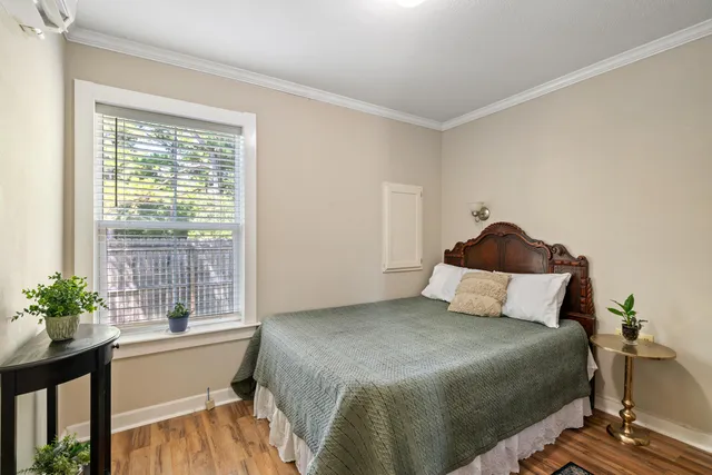 a bedroom with a bed and a window