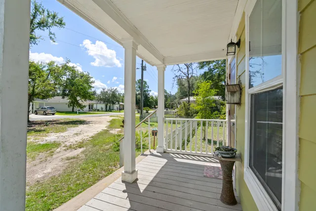 a view of a balcony with wooden floor