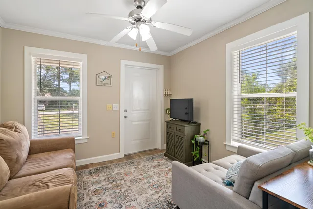 a living room with furniture and a flat screen tv